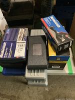 Multiple packed tool sets stacked in garage, showing boxes and cases for Mastercraft, Power Fist, and Pro Point.