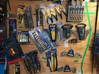 Overview of assorted hand tools laid out on plywood board