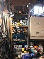 Full shelf view with power tools, tool chest, boxes and other hardware items