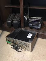 View of Centerex 8-track stereo player with Sony car stereo units and others in background.