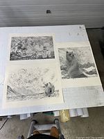 Three animal-themed black and white prints laid on a table