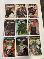 Nine Batman comic books laid out in a 3x3 grid, showing various cover designs.