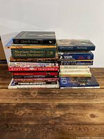 Stacked collection of books showing titles and sizes from multiple angles