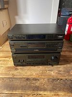 Front view of the three stacked Technics stereo components showing model names and control panels