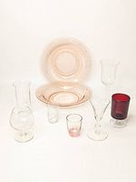 Full lot showing all glasses and plates together on white background