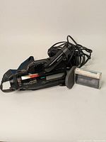 Front-left angled view of Sony Hi-8 Handicam CCD-FX710 camcorder with power adapter cable and cassette tape beside it