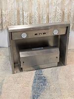 Front view of Vent-A-Hood B200 range hood showing control panel with buttons and round vents or lights.