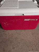 Front and side view of red and white Coleman cooler with visible scuff marks and Coleman Kwik-Serv 40 label.