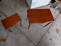 Photo showing the two wooden end tables from above, highlighting size difference and similar design.