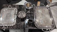 Photo showing the complete set including trays, teapot, creamer, and sugar bowl arranged on a table