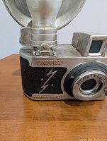 Close-up of Univex brand and lightning bolt design on camera piggy bank