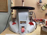 Front view of the Craftex CX-Series oscillating sander on workbench with mounted sanding drum sleeves and switches visible.