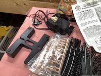 Overview of power supply, elevated track support, plastic parts, and assembly instruction manual