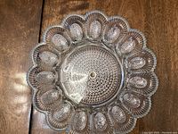 Top-down view of the vintage hobnail deviled egg platter showing 12 egg-shaped holders and detailed hobnail pattern on surface and scalloped edge.
