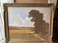 Frontal view of signed pastel landscape in carved wooden frame