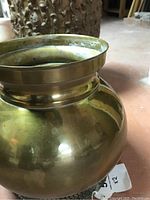 Photo of simpler brass pot with rounded body and polished surface.