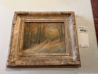 Full view of the framed original oil painting showing the wooded path scene with the road leading through trees under an overcast sky.