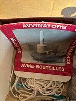Top view of original packaging showing label 'Avvinatore Sulfiter Avine-Bouteilles' and coiled white rope tubing.
