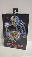 Front view of sealed Hellraiser Ultimate Pinhead action figure package showing artwork and branding.