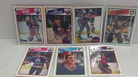 Photo showing seven hockey cards including Grant Fuhr, Pat LaFontaine, Paul Coffey, Kari Kurri, Brett Hull, and Ron Hextall from 1988 O-Pee-Chee set.