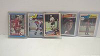 Photo of 5 vintage hockey rookie cards arranged in a row showing front images.