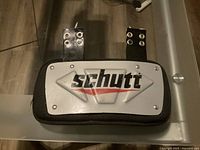 Photo of Schutt football back plate pad highlighting logo and strap attachments