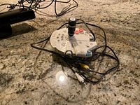 Photo of Millennium Falcon shaped remote control game with cables on countertop