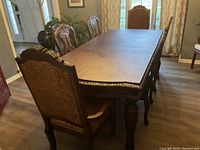 Full dining table with six chairs around it, showing overall look and design.