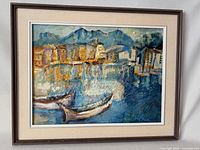 Full view of the framed impasto oil painting showing the harbor scene with boats and buildings against mountain background.