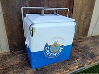 Cooler showing front and side with Creemore logo and minor paint chipping