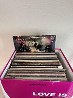 Box of vintage vinyl records showing Kiss album cover on top, with intact but worn edges
