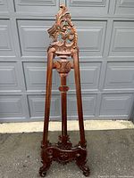 Full view of large antique wooden easel showing overall structure and ornate design