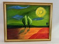 Frontal view of the framed oil painting on board showing the stylized landscape with two trees, sun, clouds, and small figures, signed bottom right.