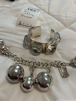 Overview of both sterling silver bracelets on white background, showing cuff and chain layouts