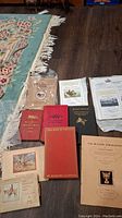 Overview of eight foxhunting books and ephemera laid out on floor