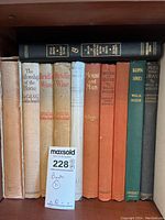 Shelf view showing nine dust-jacketed and cloth-bound equestrian titles