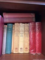 Shelf view showing two red cloth bound volumes