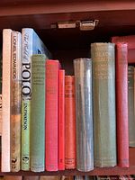 Shelf view of nine horse-themed hardcover books showing spines and dust jackets