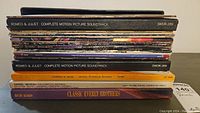 Stacked vinyl records highlighting 'Romeo & Juliet Complete Motion Picture Soundtrack', 'Lawrence of Arabia', 'Handel Messiah', and 'Classic Everly Brothers' albums.