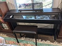 Full front view of Yamaha Clavinova keyboard with bench