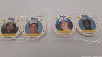 Four 1987 Hostess baseball chip cards featuring Hubie Brooks, Jimmy Key, Mitch Webster, and Lloyd Moseby placed side by side in plastic sleeves