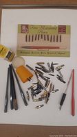 Full lot overview showing all pen nibs, pen holders, and original pack of Fine Mapping Pens nibs.