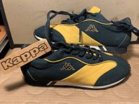 Side view of brand new Kappa running shoes in royal blue and yellow leather, showing Kappa tag and lace-up style.