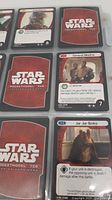 Close-up of Star Wars PocketModel TCG cards showing character cards including General Madine and Jar Jar Binks, with backs showing the game logo.