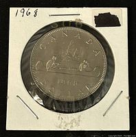 Reverse side of the 1968 Canadian 1 dollar coin showing the canoe scene and the year 1968.