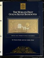Front cover of display card labeled 'The World's First Gold & Silver Banknotes' featuring gold foil banknote mounted in center with official text.