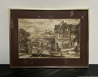 Framed lithograph print showing entire artwork in frame against white wall background and black surface
