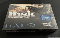Front view of the Risk Halo Legendary Edition board game box shrink-wrapped and unopened.