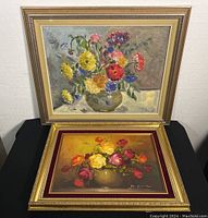 Both flower paintings framed, showing size and detail of floral arrangements and framing style.