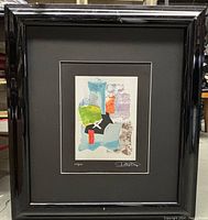 Framed lithograph print by Das Laszlo with black frame and black matting, showing full framed artwork.